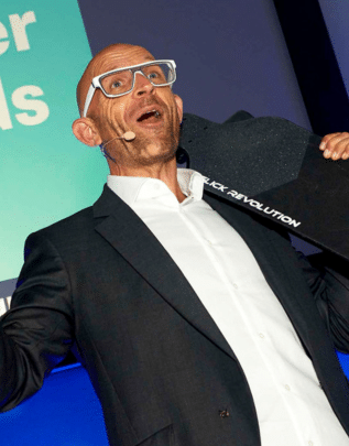 A man presenting on stage